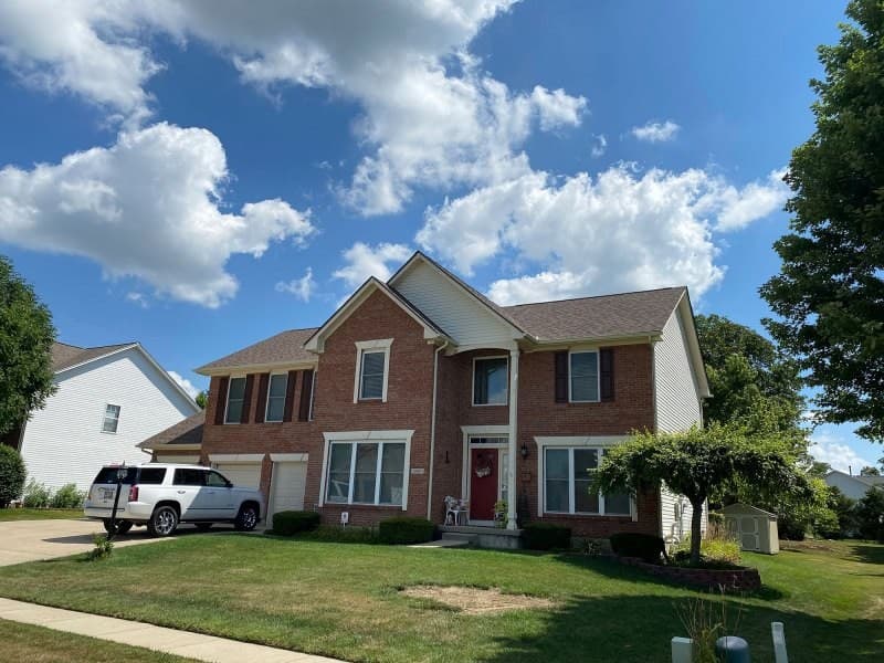 Brick two-story house with shingle roof